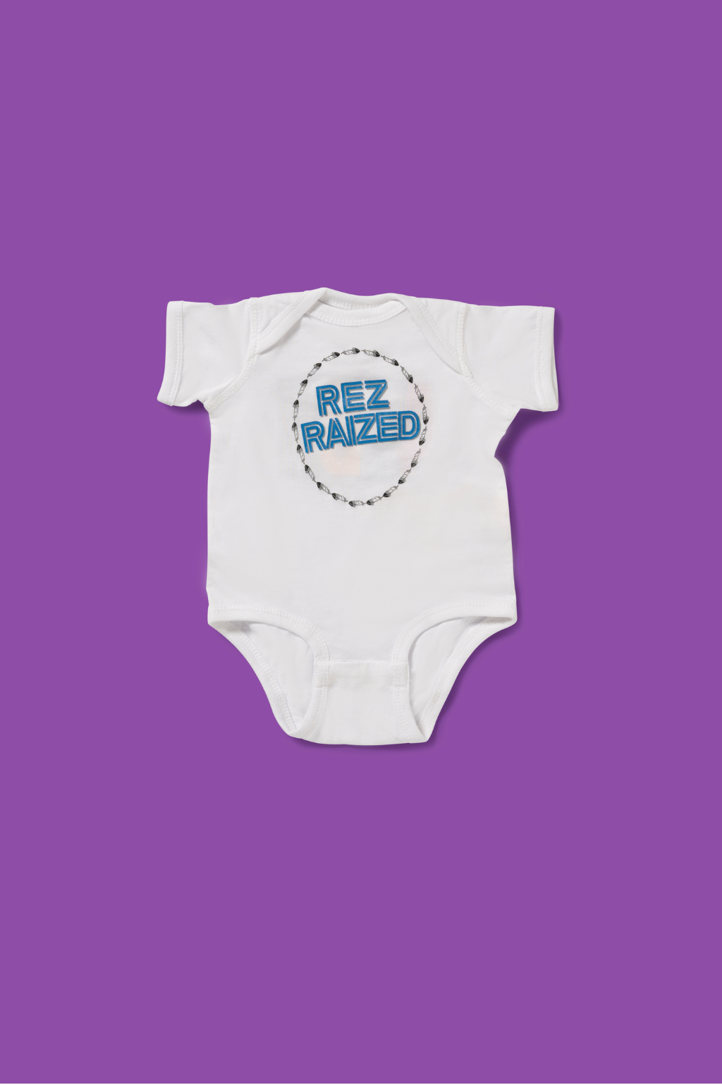 Rez Raized baby onesie – Native-inspired infant bodysuit with bold lettering design